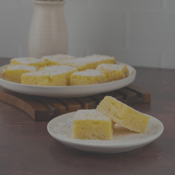 Yellow cake slices on white plates