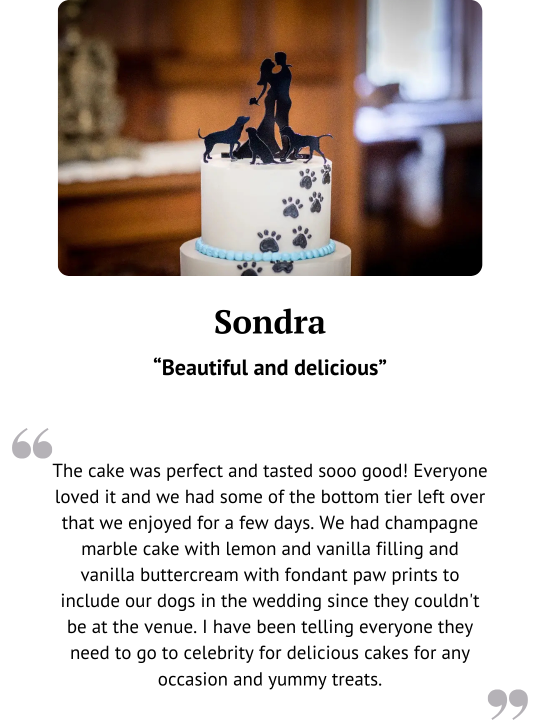 Two-tier wedding cake with dark ribbon and figurine topper