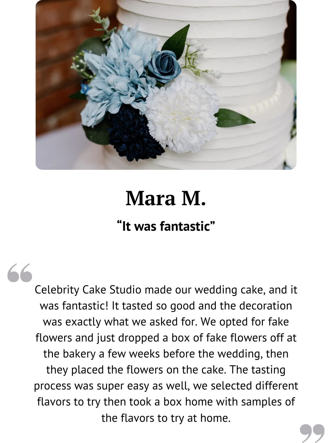 White wedding cake decorated with blue and white flowers