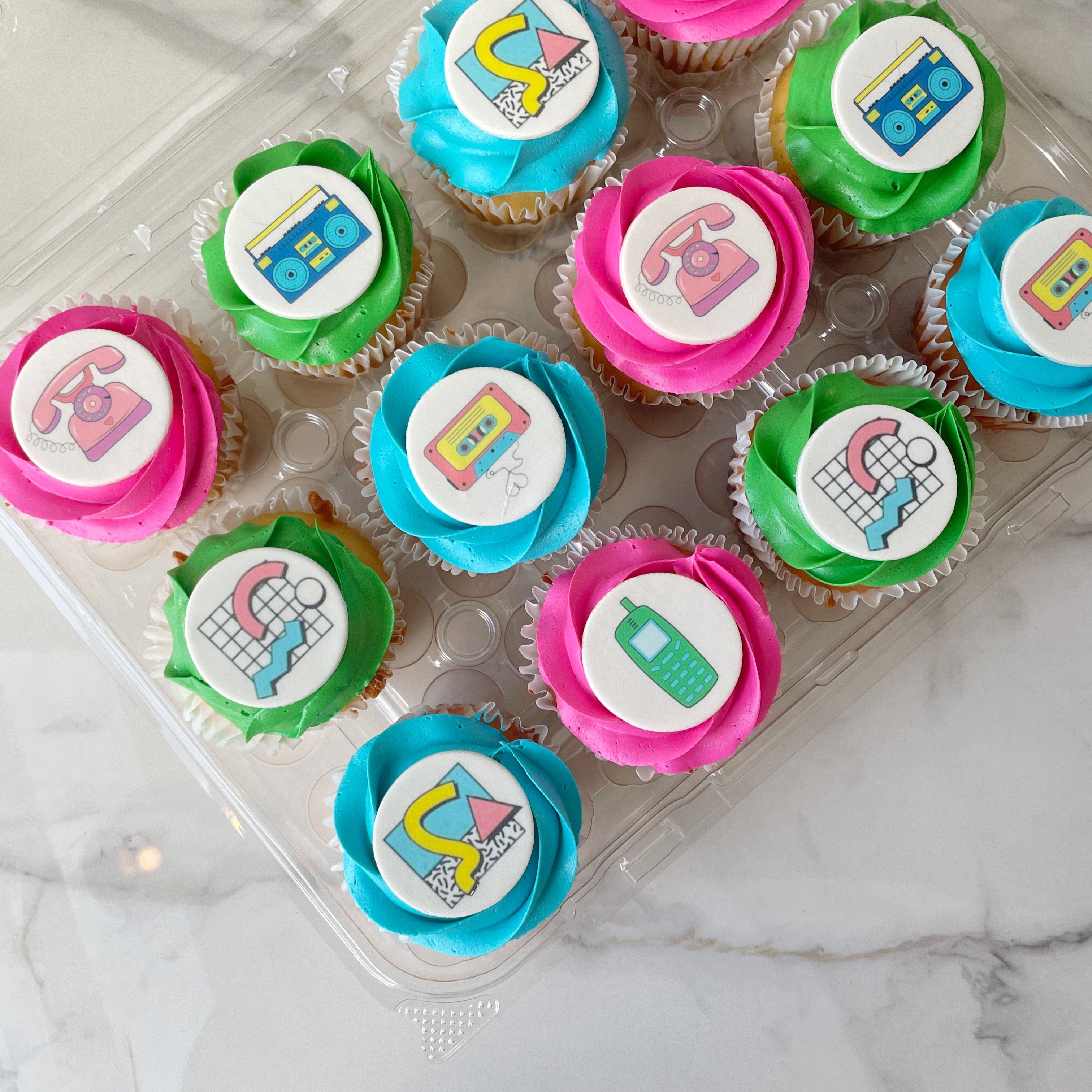 Brightly colored cupcakes decorated with telephones