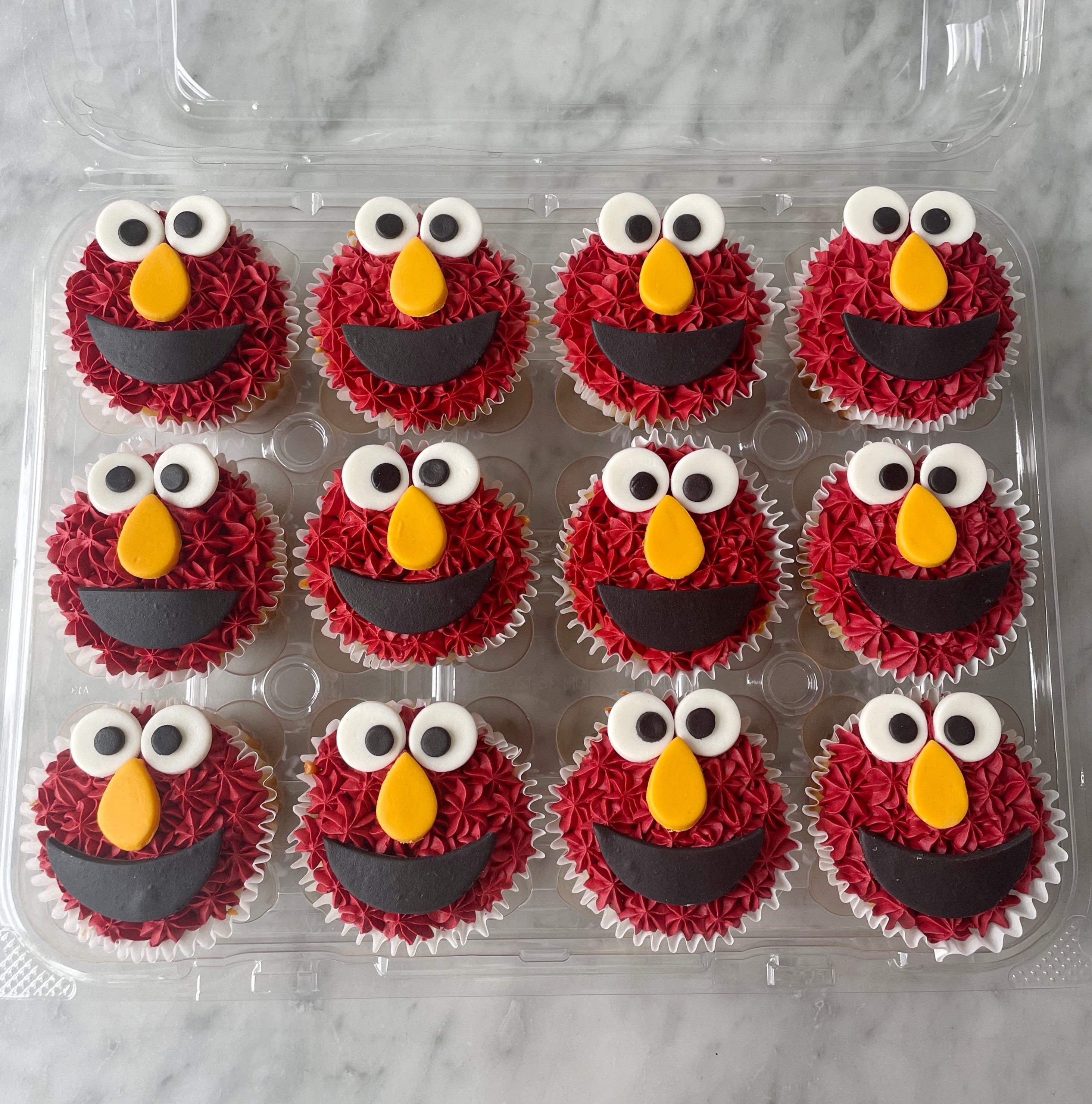 Elmo-themed cupcakes with red frosting