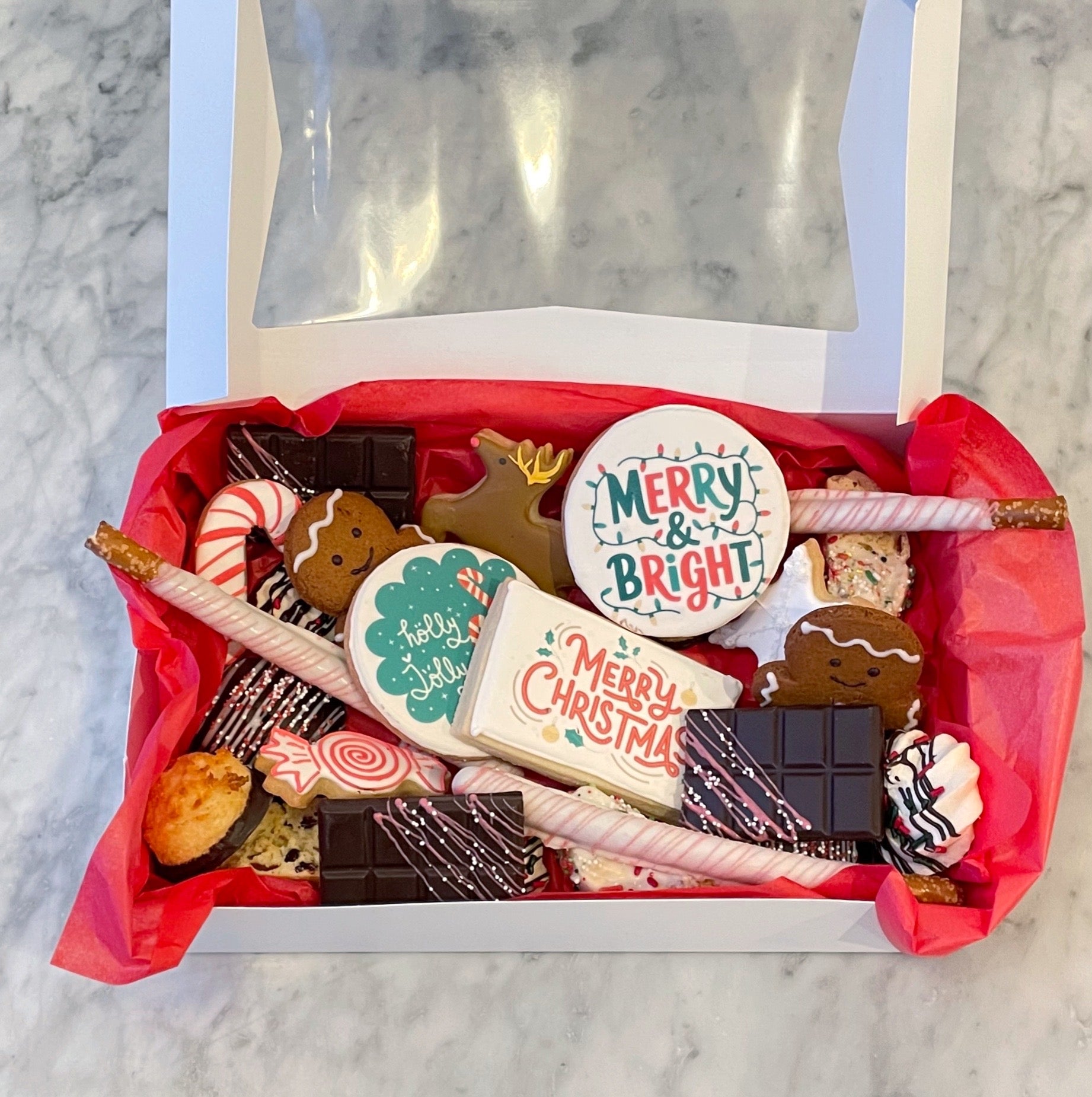 Festive gift box with assorted cookies and holiday treats