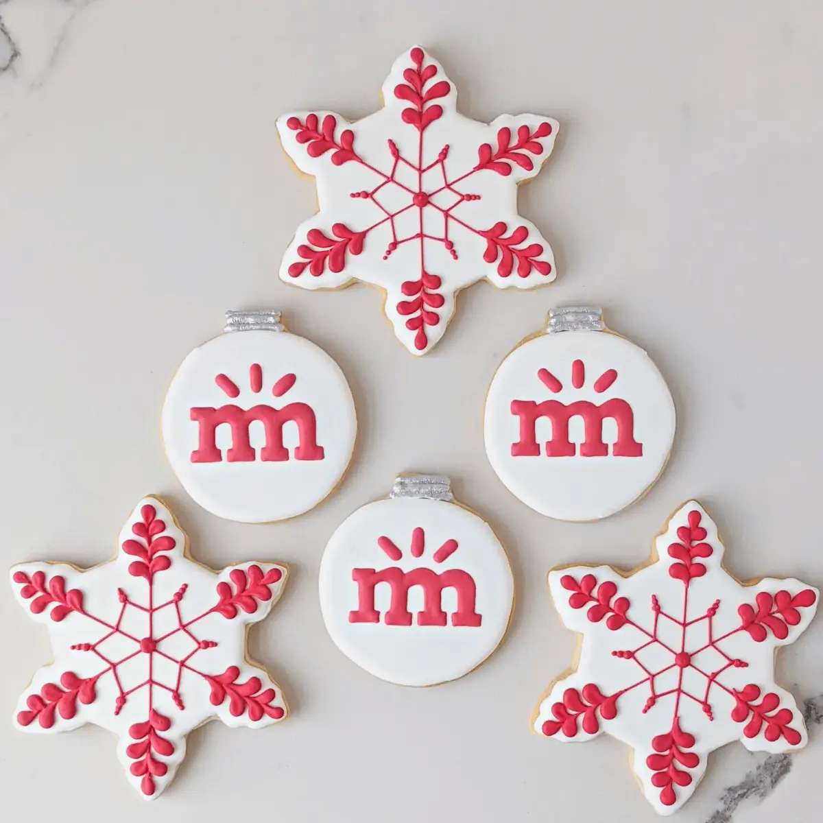 Snowflake cookies with pink crowns and snowflake designs