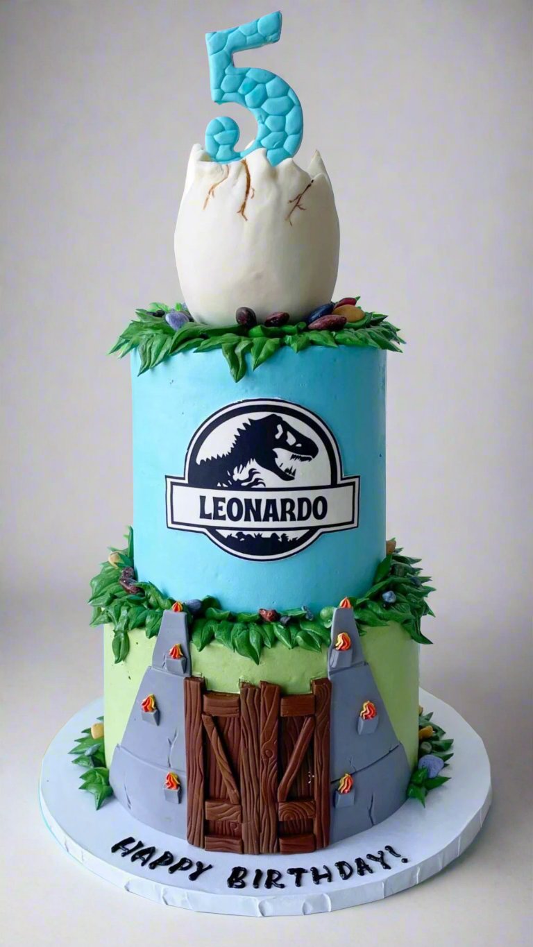 Three-tier cake with a number 5 topper, featuring a green monster theme and tree trunk base