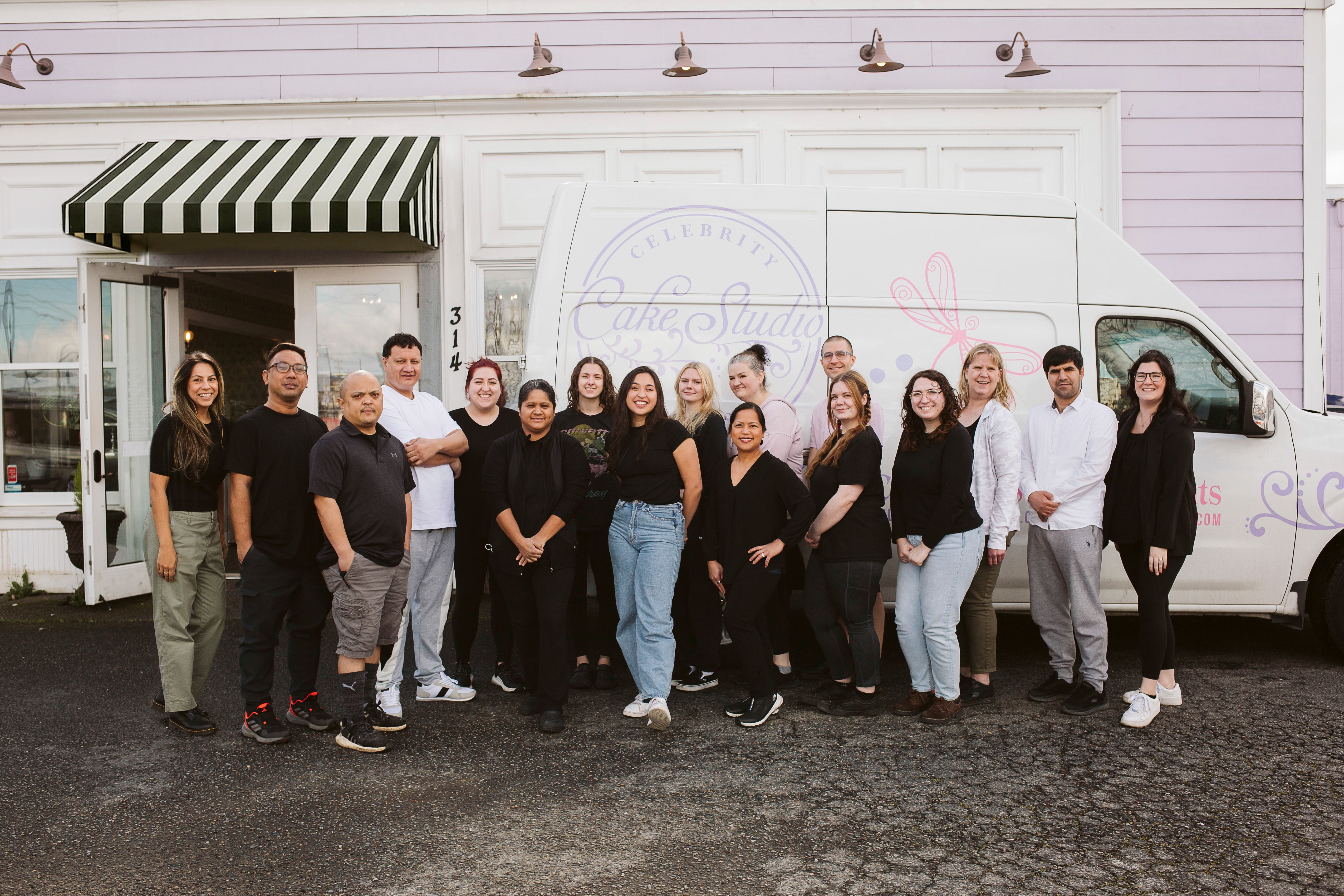 Group photo of the bakery team posing together in front of the shop