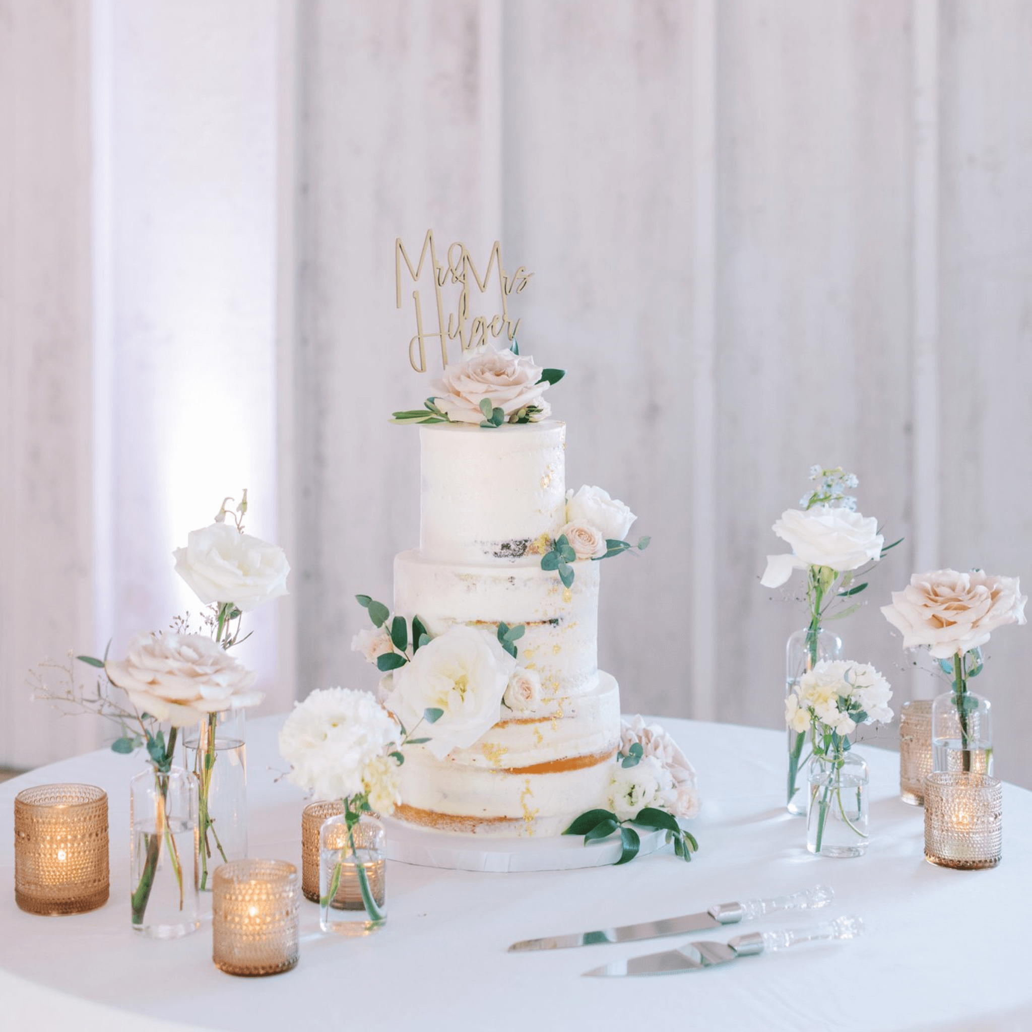 A multi-tiered wedding cake with a "Mr & Mrs" topper.