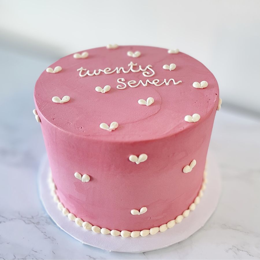 pink cake with tiny hearts piping design