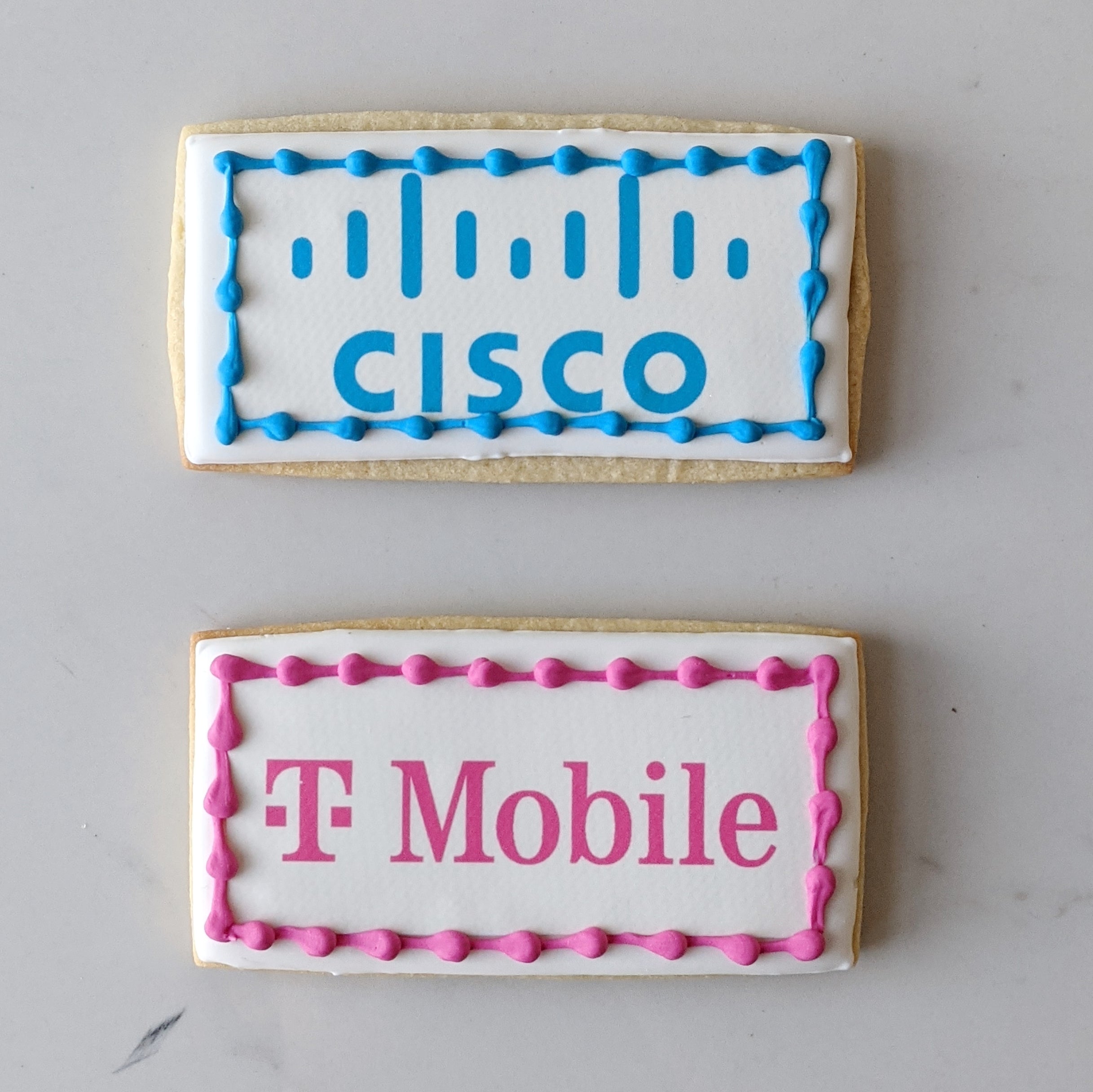 Two cookies with Cisco and T-Mobile logos
