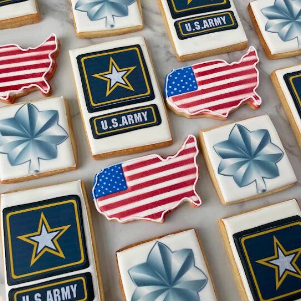Cookies with U.S. Army logo and American flag design on a marble surface