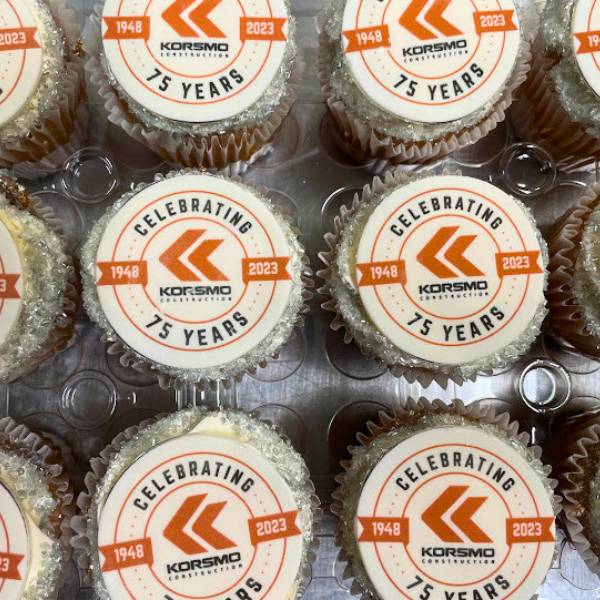 Cupcakes with Korsmo Construction branding celebrating 75 years.