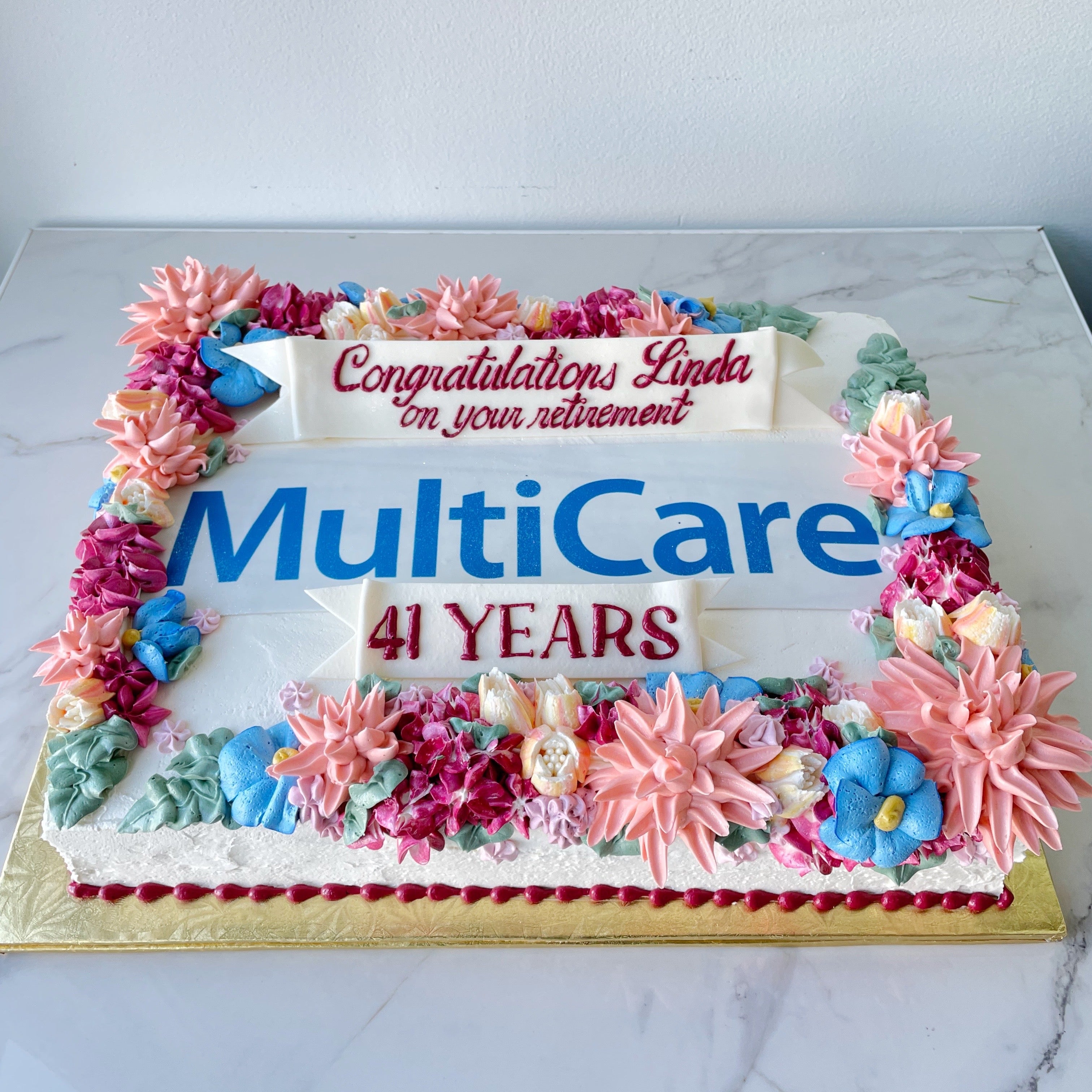 Decorative cake with floral decorations and text 