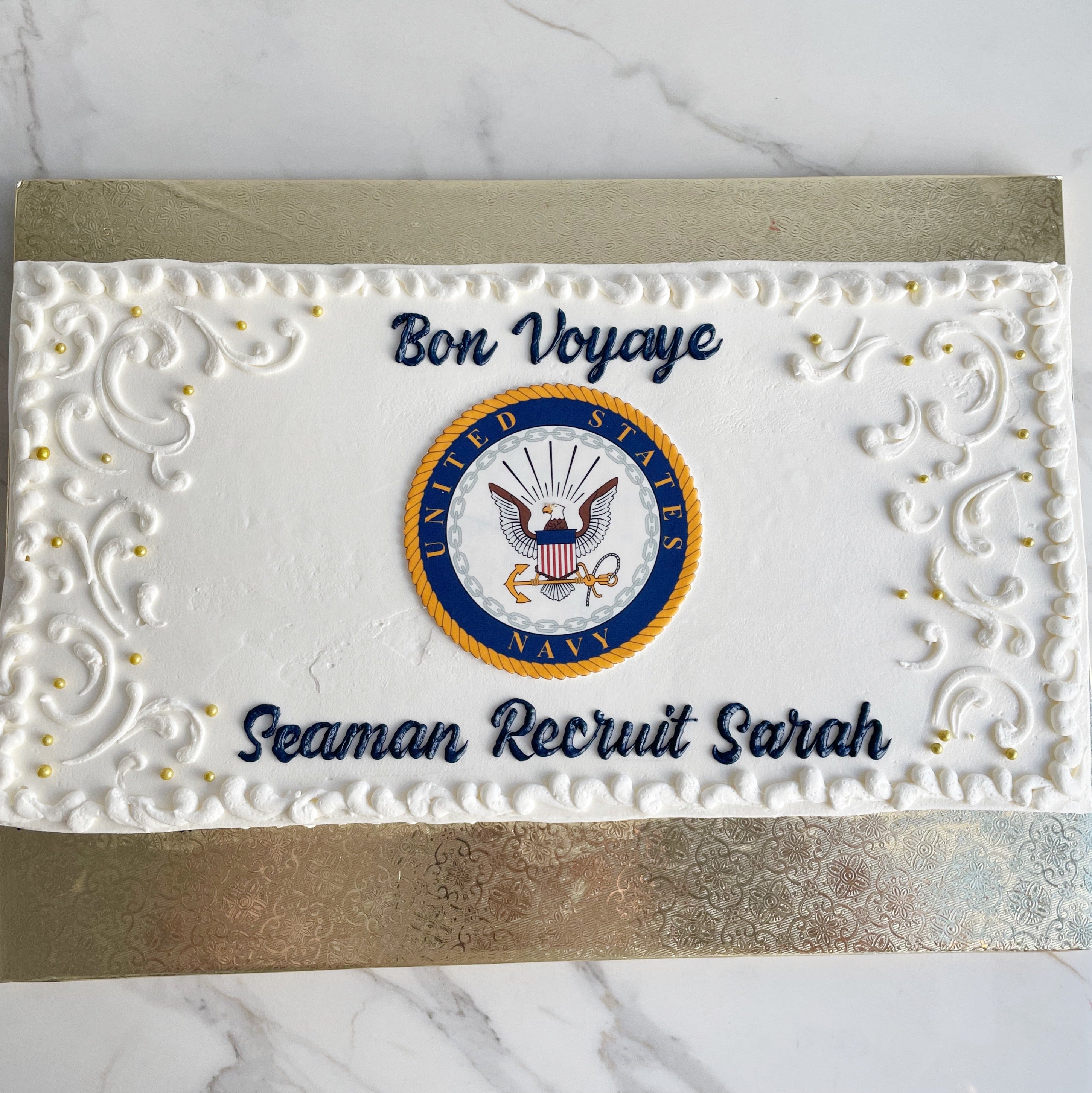 Greeting card with U.S. Navy emblem and text 'Bon Voyage Seaman Recruit Sarah' on a marble background