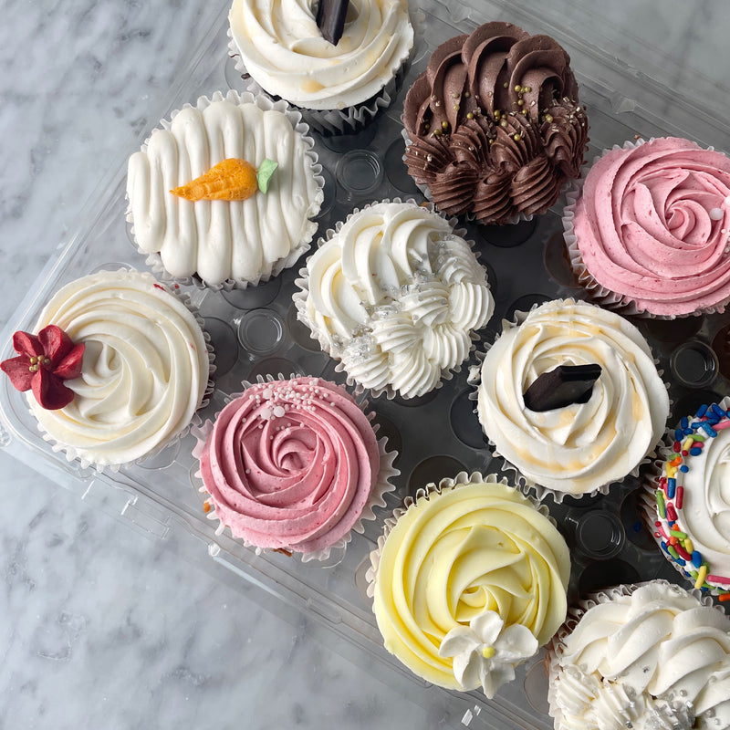 Assorted cupcakes with different frosting colors and designs 