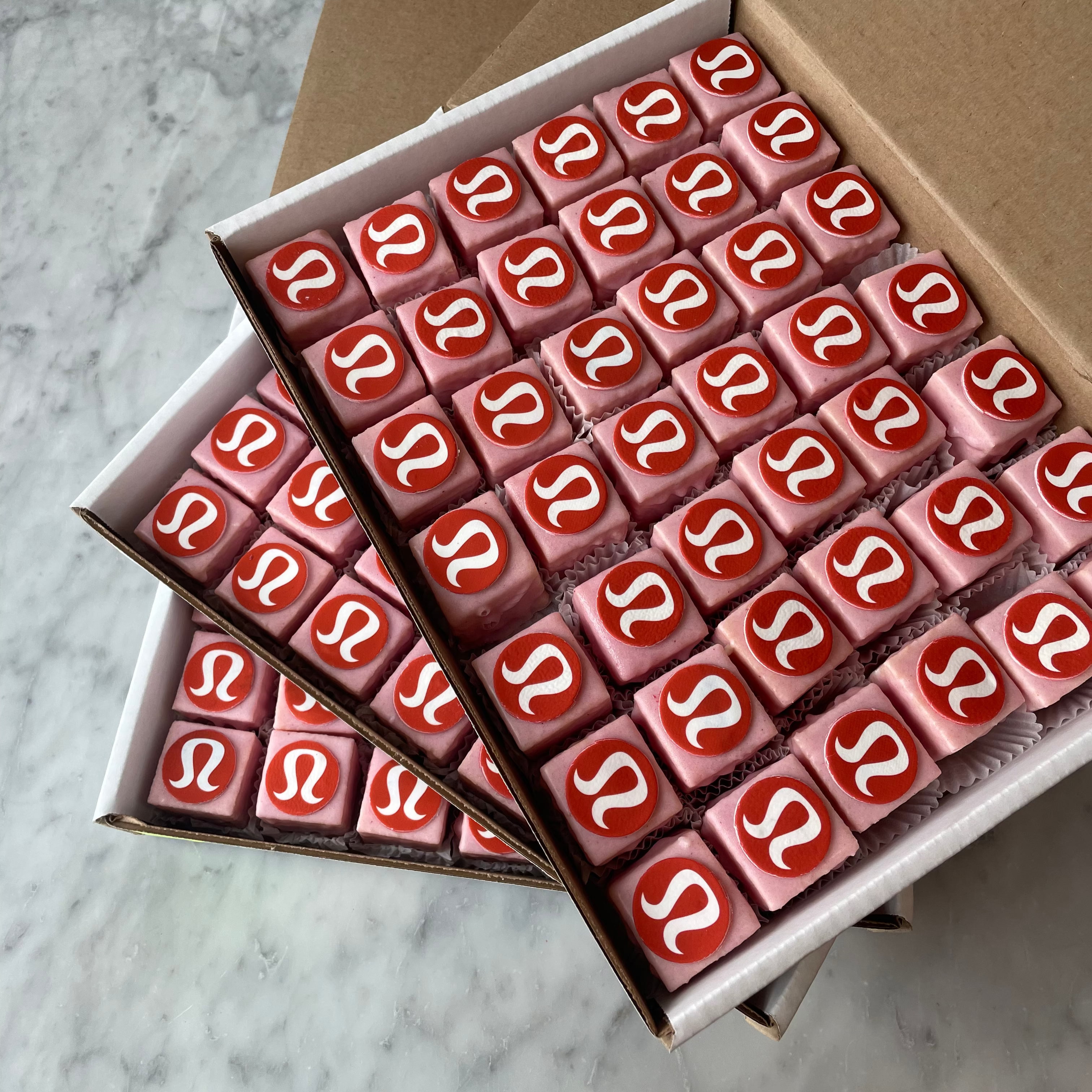 Box of chocolates with a logo on a marble surface