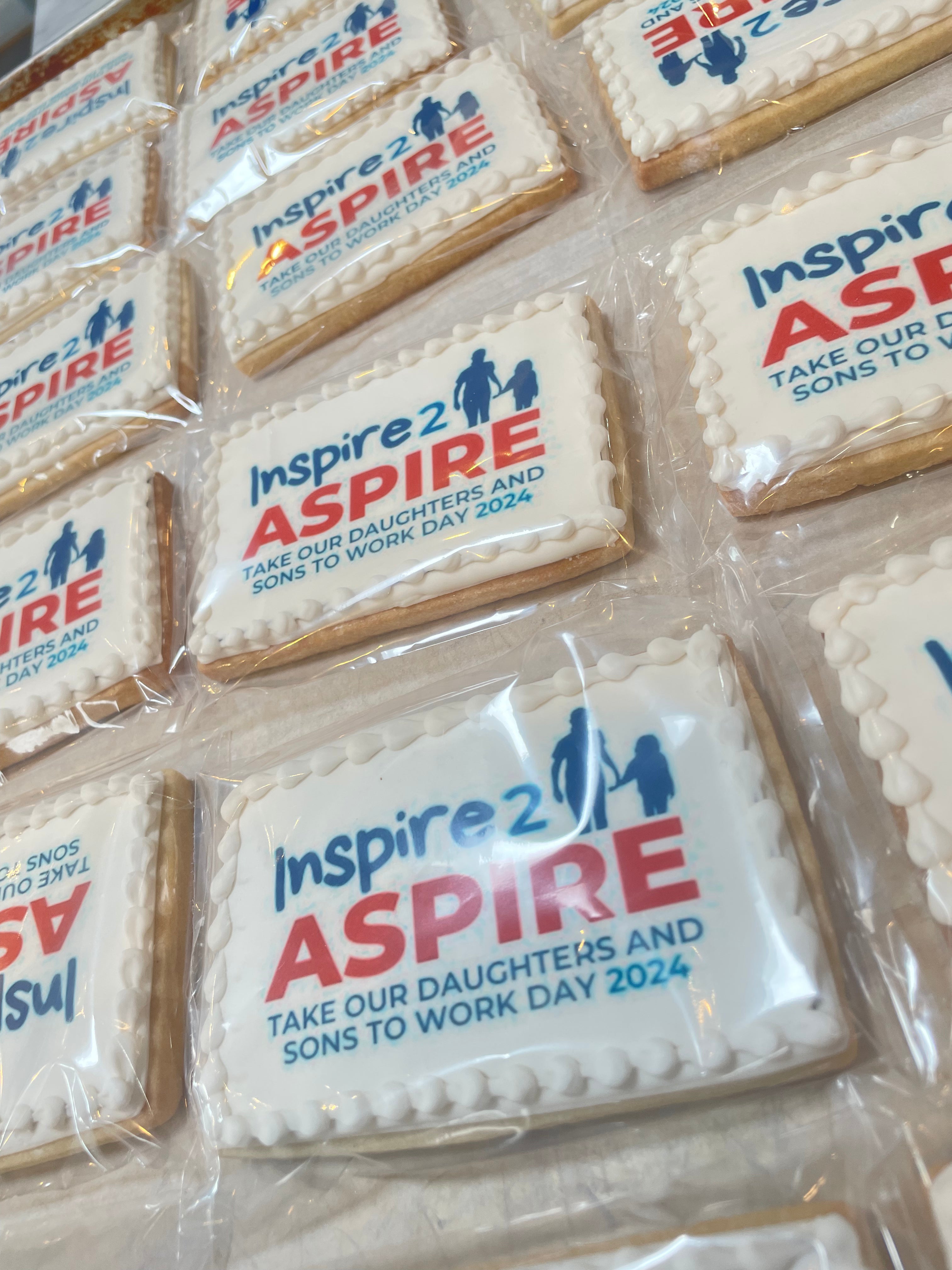 Cookies with 'Inspire 2 Aspire' branding and text