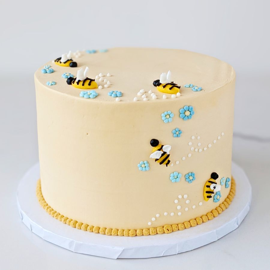 Bees and flowers cake on a white background