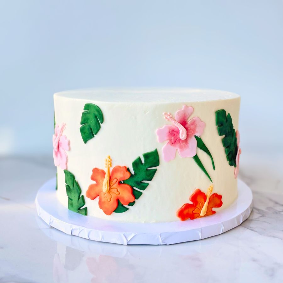 Decorative cake with floral designs on a marble surface